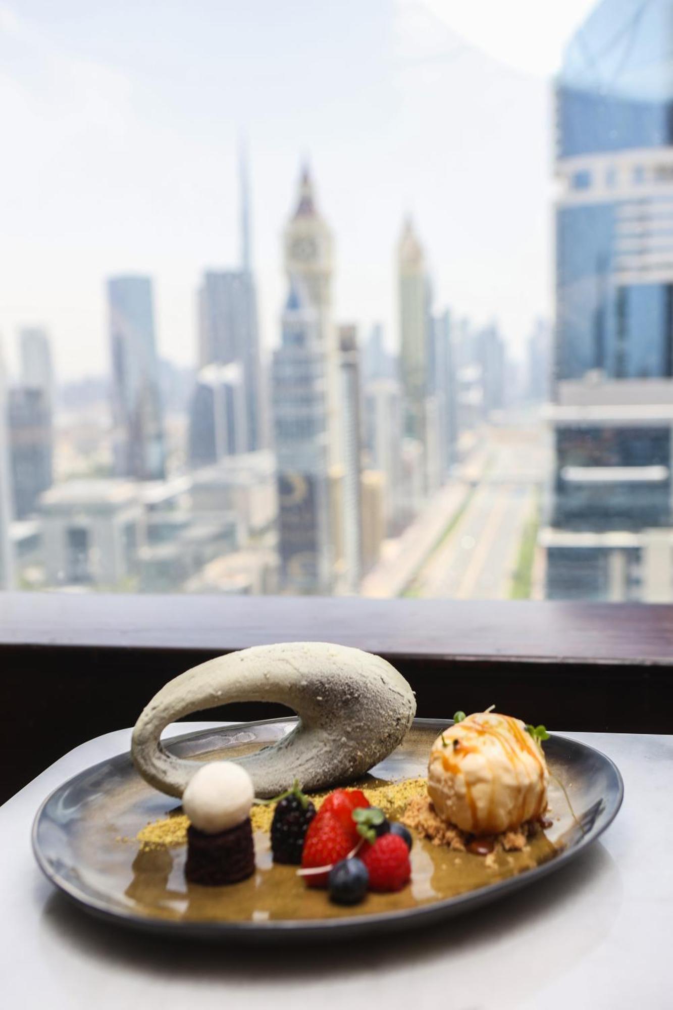 Nassima Tower Hotel Apartments Dubai Exterior photo A view of the Dubai skyline from the restaurant