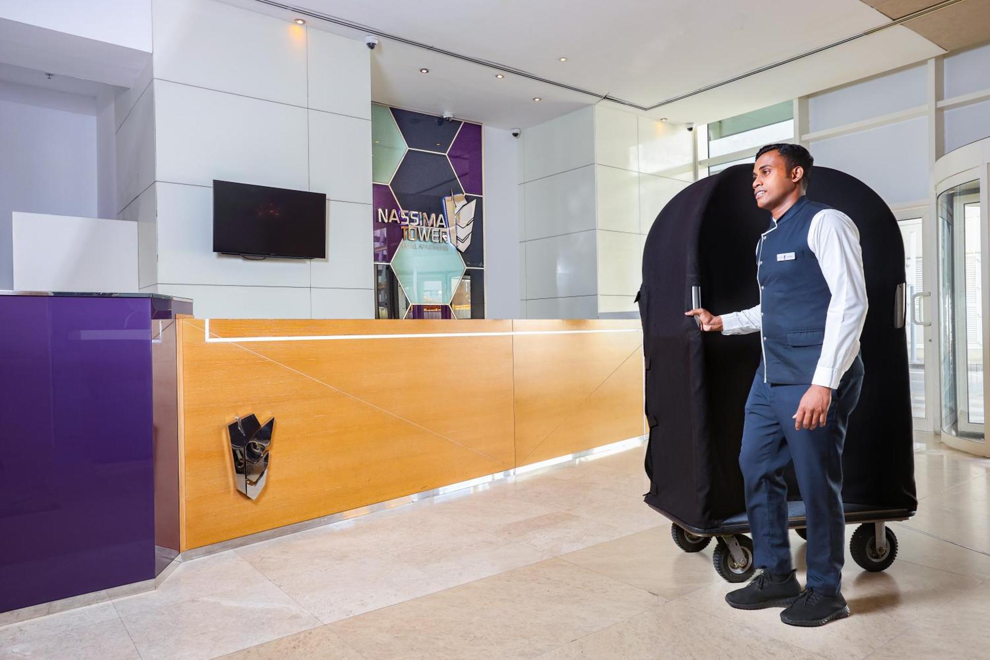 Nassima Tower Hotel Apartments Dubai Exterior photo A bellboy with a luggage cart