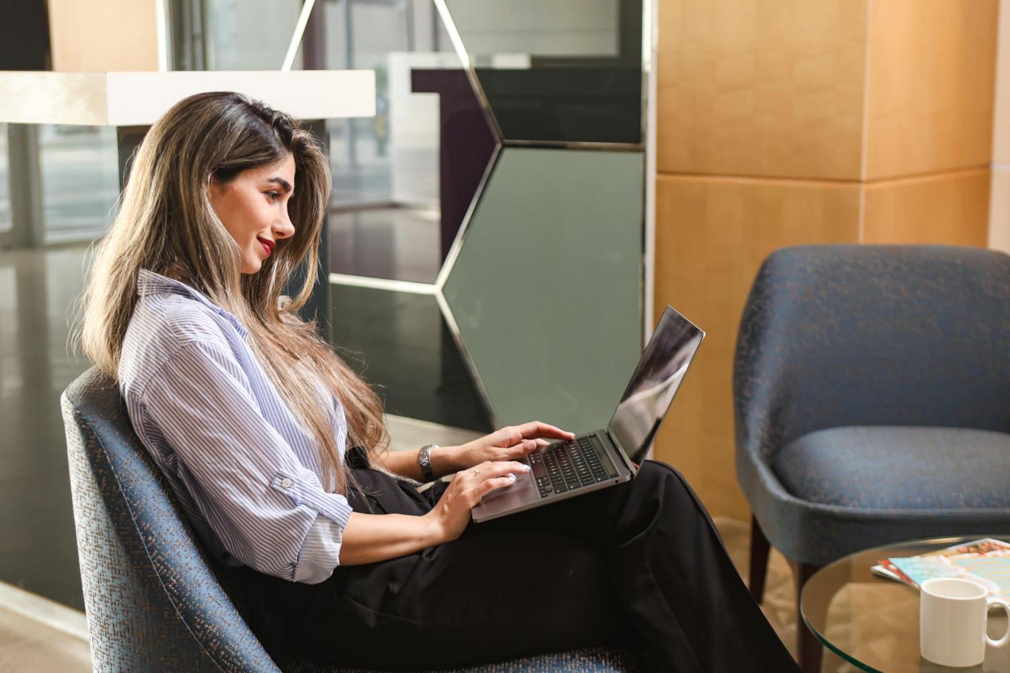 Nassima Tower Hotel Apartments Dubai Exterior photo A woman using a laptop